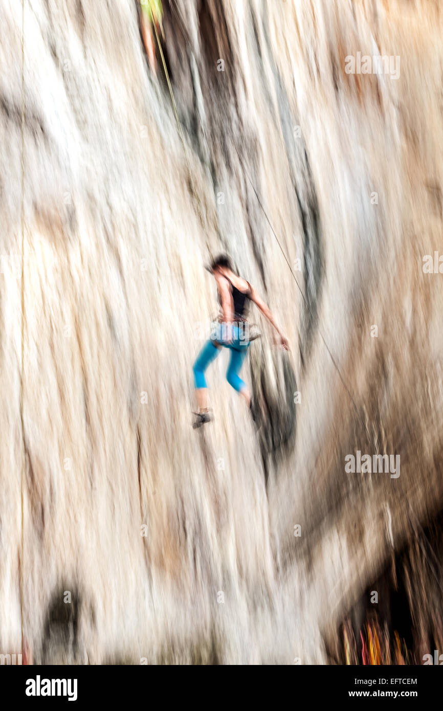 Motion blurred rock climber falling down. Stock Photo