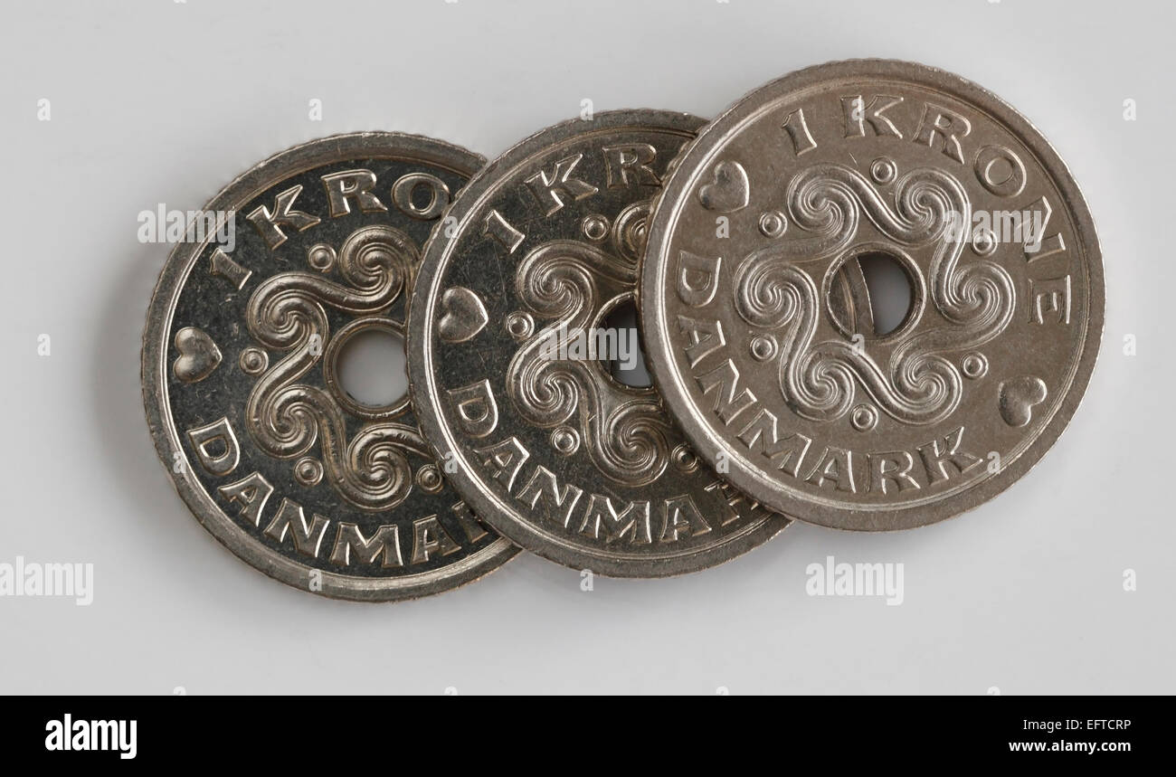 Three Danish one Kroner pieces on a white background Stock Photo
