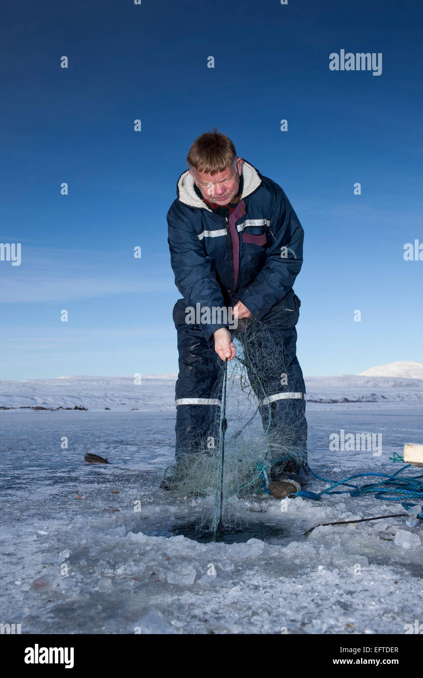 Ice fishing for arctic char on Lake Thingvellir, Thingvellir National Park, Iceland Stock Photo