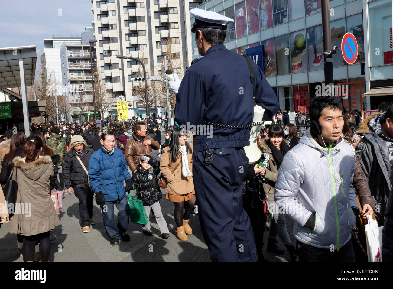 Police controlling crowds of shoppers, Tokyo, japan Stock Photo