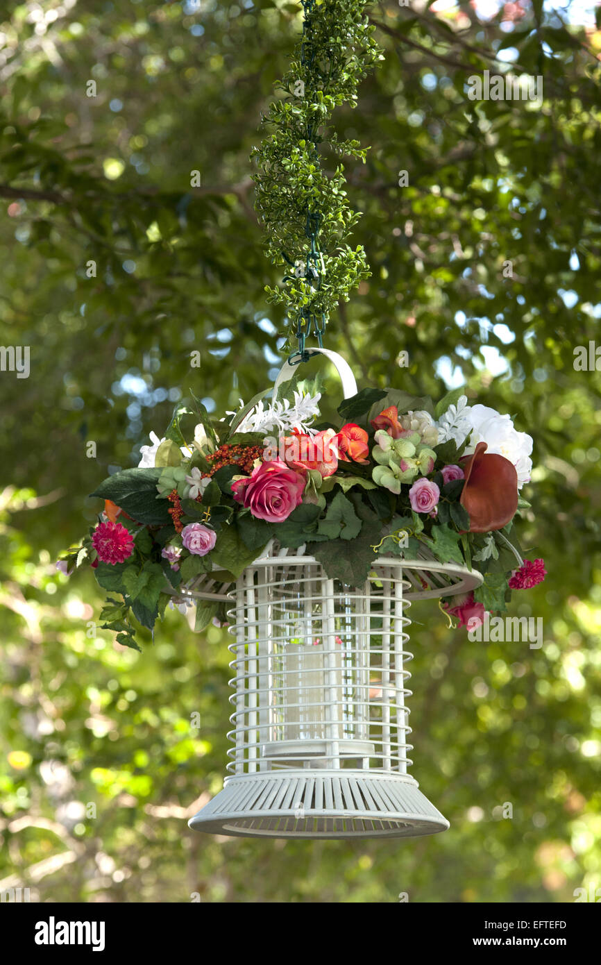 Candle holder. It is an enclosed "cage" hanging from a tree branch