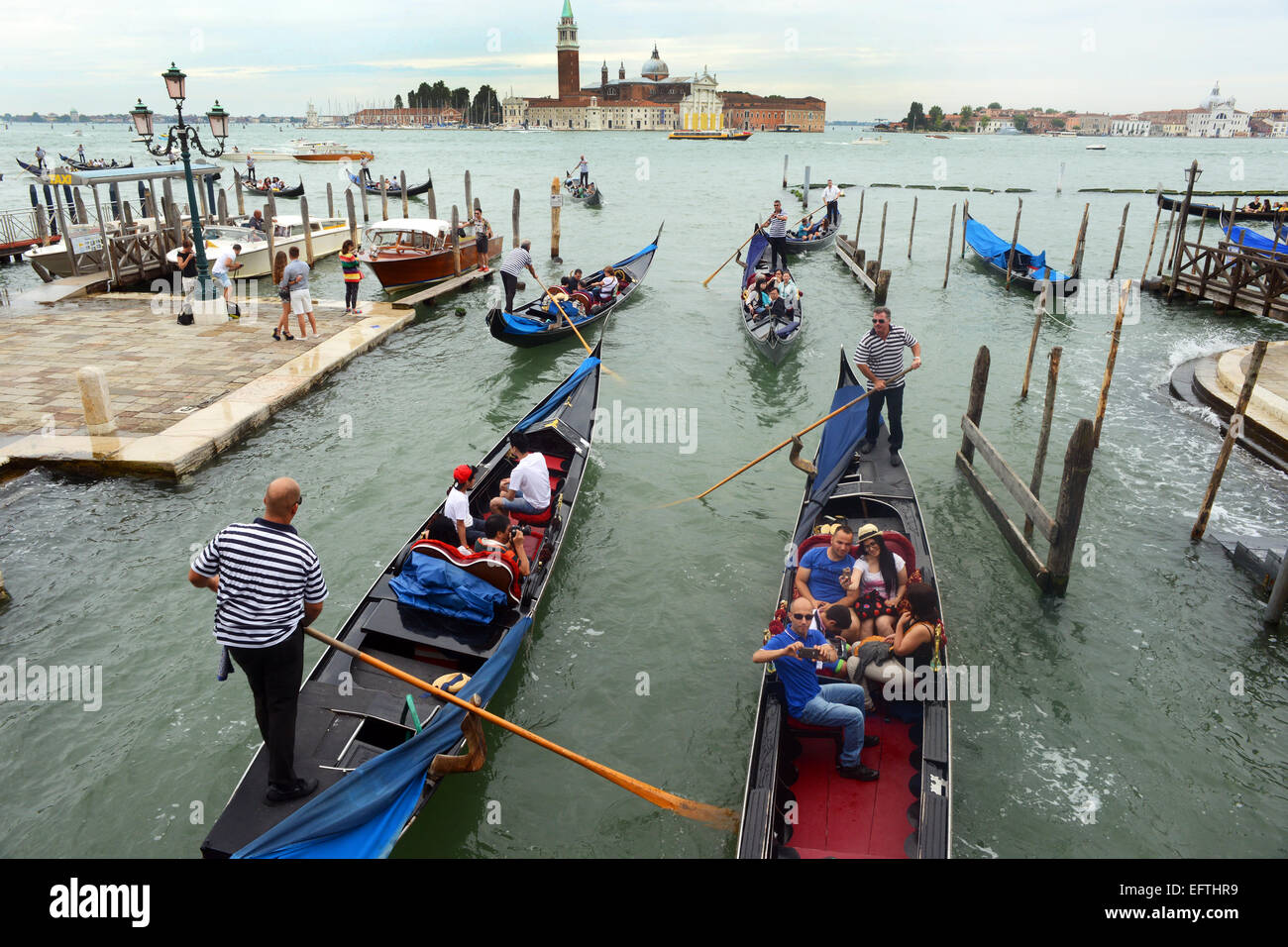 Venice Gondola transports tourists across the Grand Canal. Stock Photo