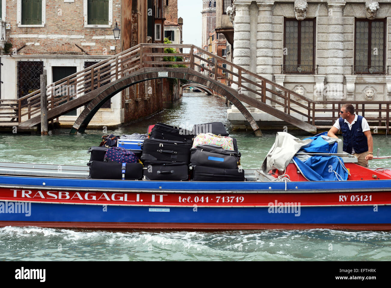 Boat transports tourist luggage up and down the Grand Canal, Venice Italy. Stock Photo