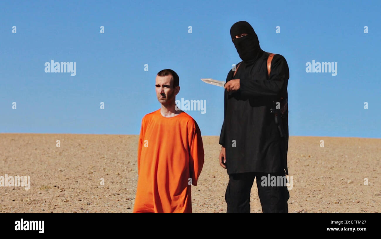 Islamic State of Iraq and the Levant fighter prepares to behead British aid worker David Haines in a propaganda video released by the organization September 14, 2014. Haines, who was 44, was kidnapped last year while working for French humanitarian aid agency in Syria in March 2013. Stock Photo