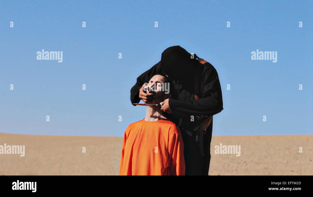 Islamic State of Iraq and the Levant fighter prepares to behead British aid worker David Haines in a propaganda video released by the organization September 14, 2014. Haines, who was 44, was kidnapped last year while working for French humanitarian aid agency in Syria in March 2013. Stock Photo