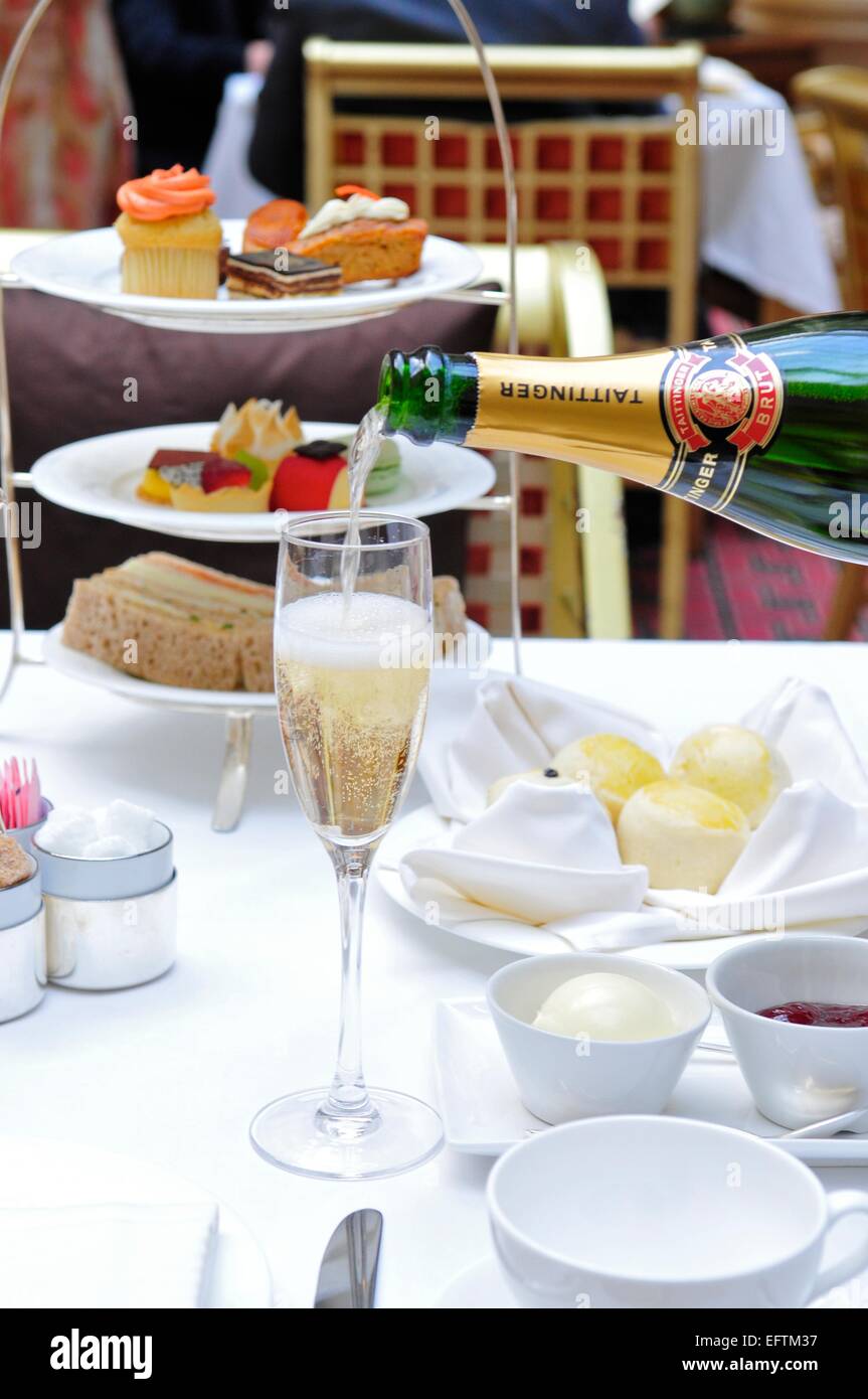 A Glass of Champagne Being Poured at Afternoon Tea at the Landmark Hotel, London, England, UK Stock Photo