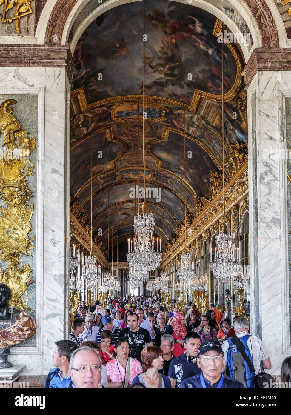 VERSAILLES, FRANCE - AUGUST 28 2013: Versailles, crowds of tourists visiting Palace of Versailles, Hall of Mirrors Stock Photo
