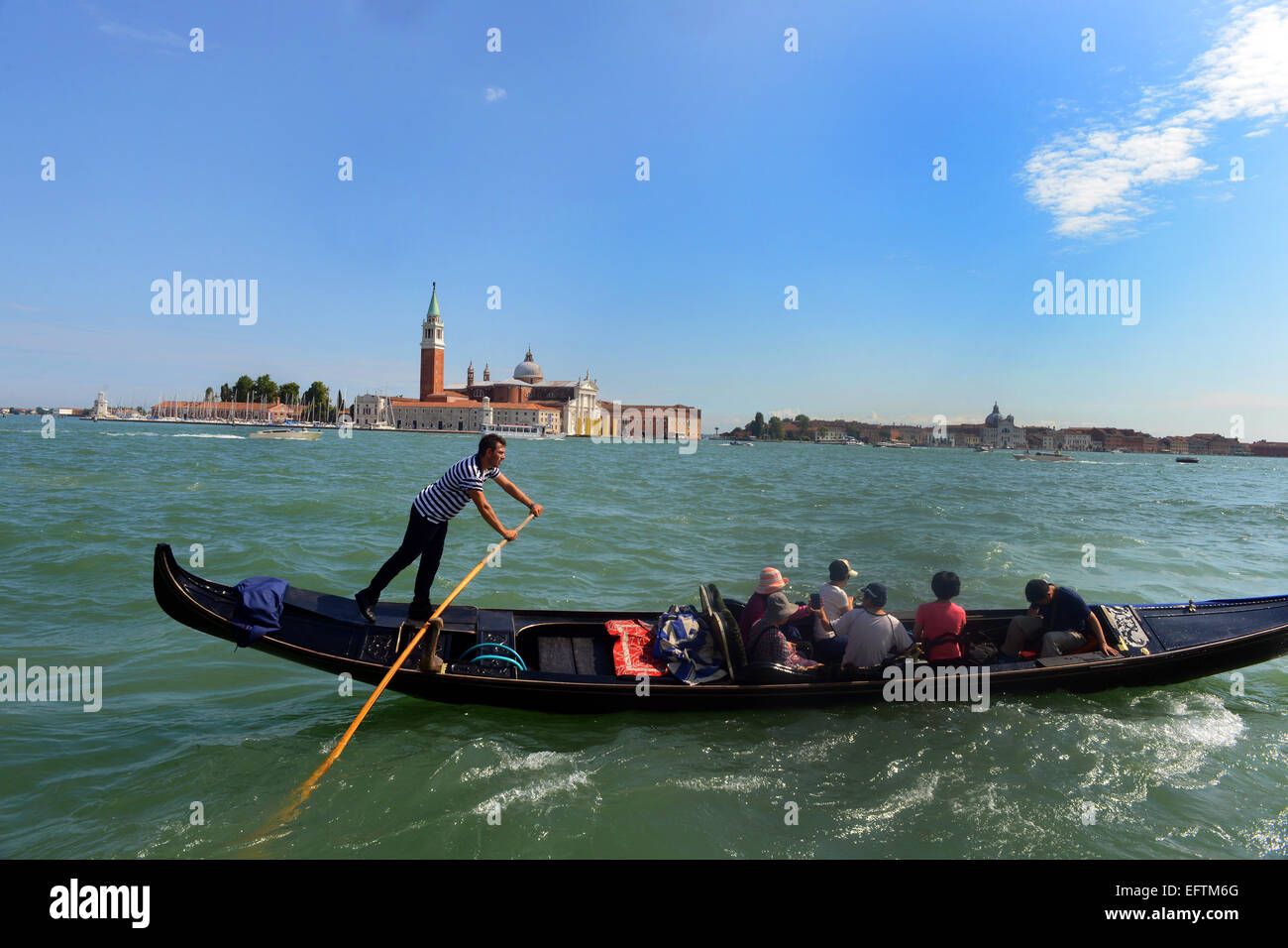 Venice Gondola transports tourists across the Grand Canal. Stock Photo