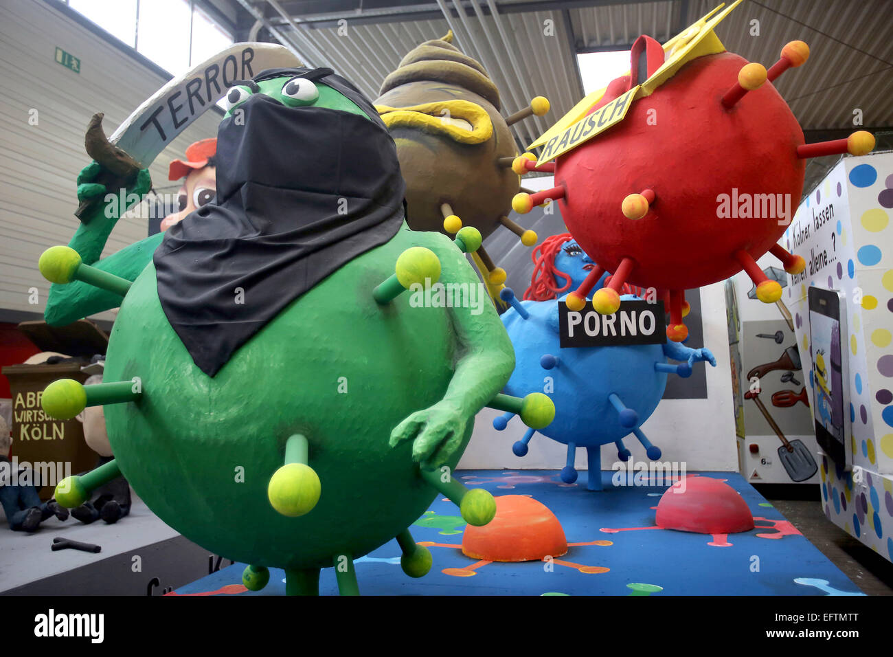 Cologne, Germany. 10th Feb, 2015. A float dealing with current topic such as terror and shopping frenzy in the float hall in Cologne, Germany, 10 February 2015. The Cologne Carnival festival committee is presenting the floats for the Rose Monday parade. Photo: OLIVER BERG/dpa/Alamy Live News Stock Photo