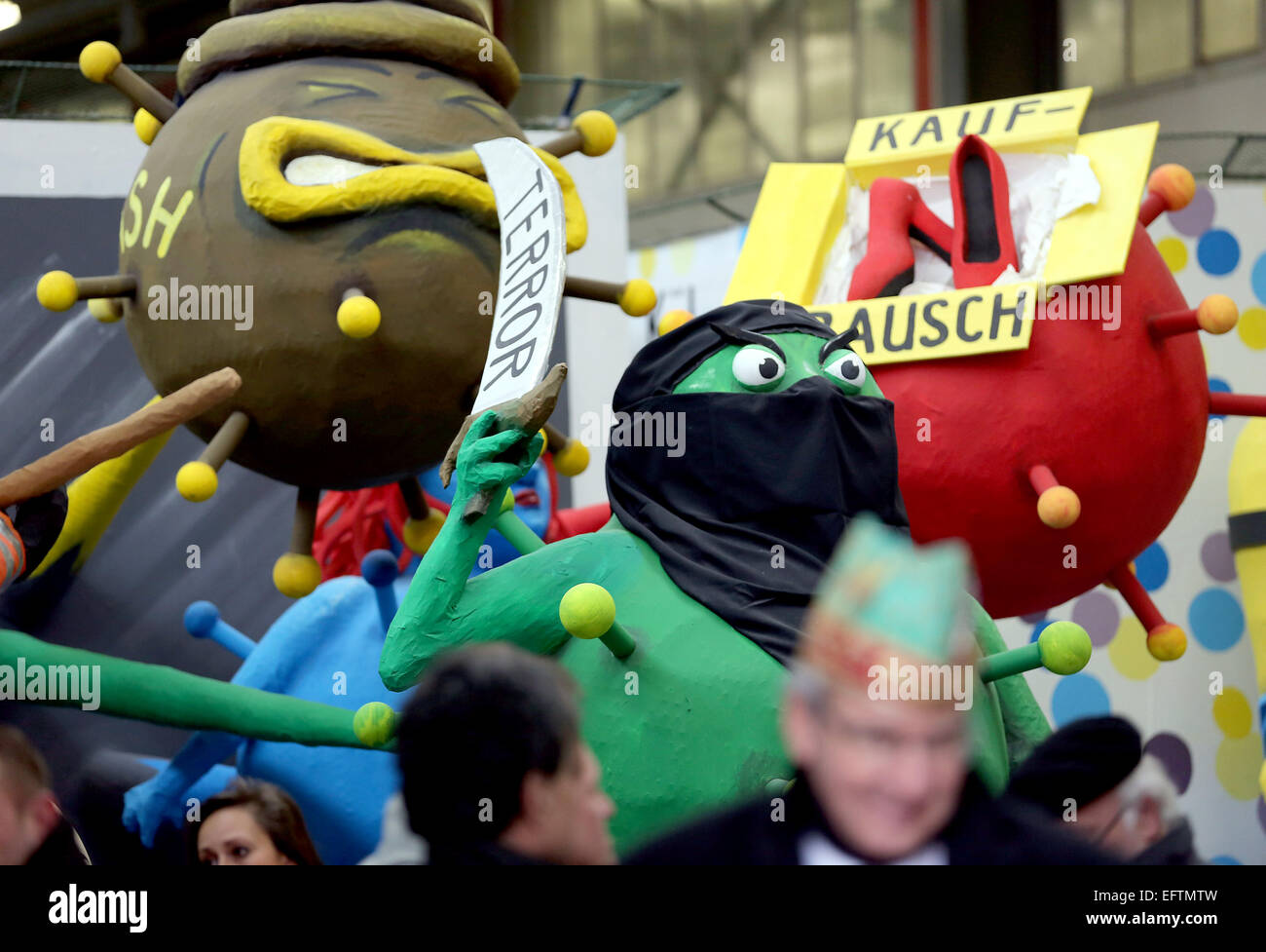 Cologne, Germany. 10th Feb, 2015. A float dealing with current topic such as terror and shopping frenzy in the float hall in Cologne, Germany, 10 February 2015. The Cologne Carnival festival committee is presenting the floats for the Rose Monday parade. Photo: OLIVER BERG/dpa/Alamy Live News Stock Photo