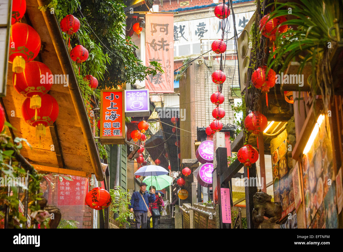 JIUFEN, TAIWAN - JANUARY 17, 2013: Tourists stroll through quaint alleys of Jiufen. The town is a tourist attraction renown for  Stock Photo