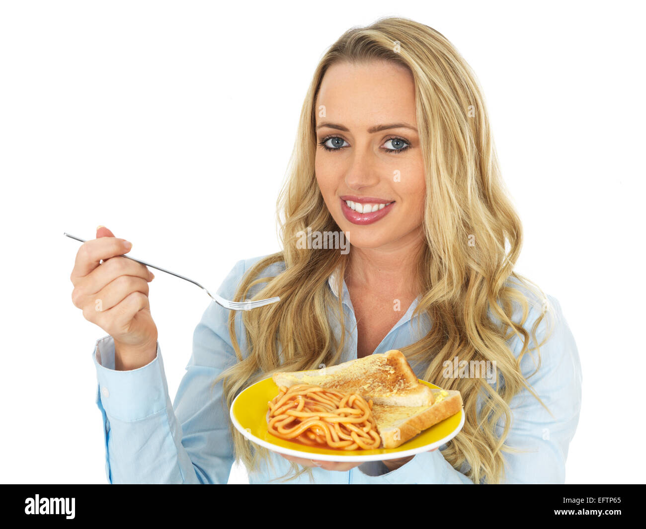 Attractive Young Woman Eating Spaghetti on Toast Stock Photo