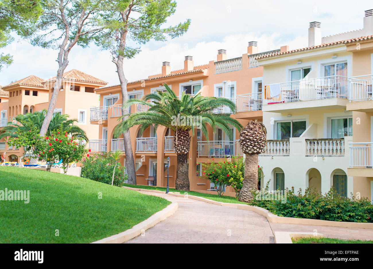 Portrait of tropical apartment building with trees Stock Photo Alamy