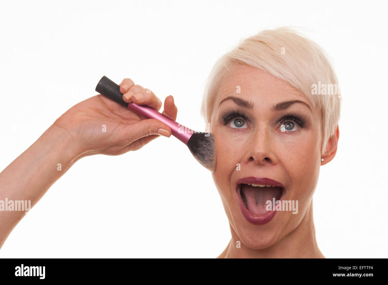 mature woman applying make up with a brush , short blonde hair Stock Photo  - Alamy