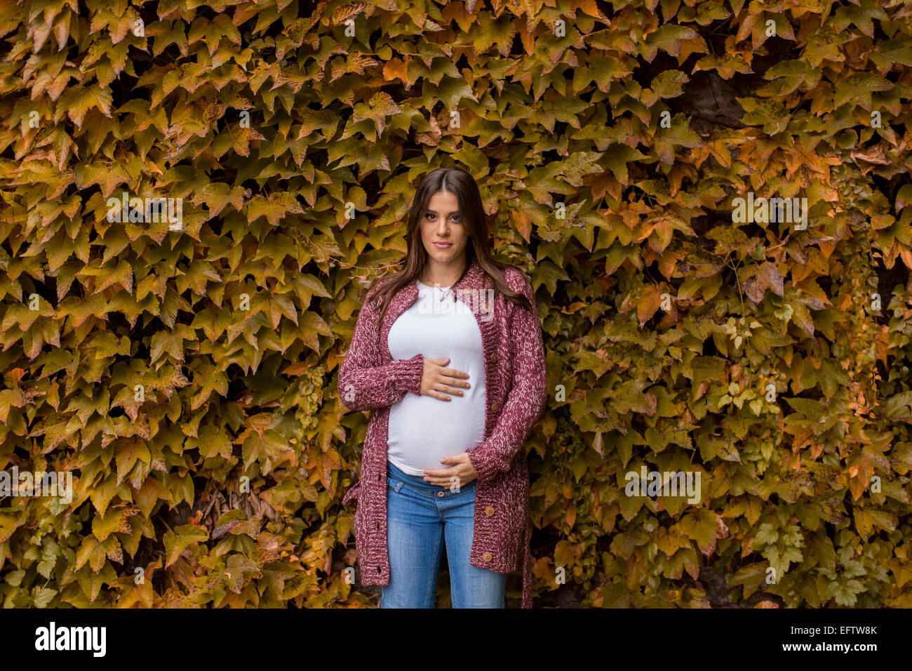 Young pregnant woman in the autumn park Stock Photo - Alamy