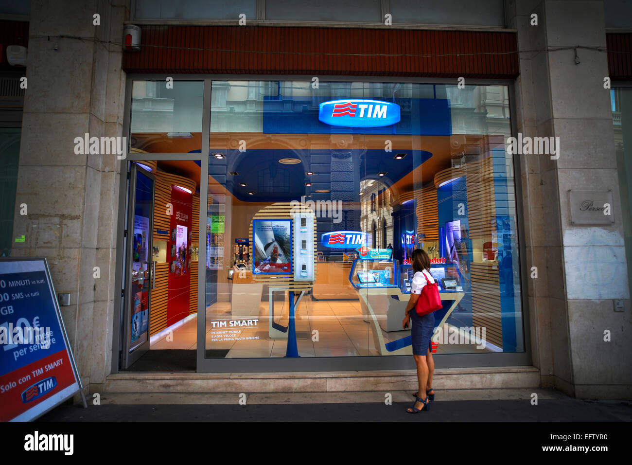 A pedestrian looks in a TIM (Telecom Italia Mobile) store window in Chieti,  Italy. EDITORIAL USE ONLY Stock Photo - Alamy