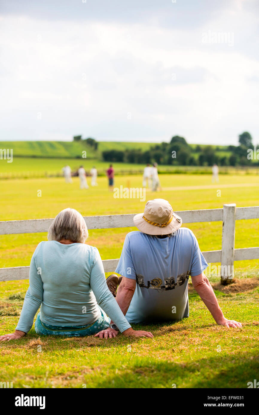 Rear view of couple watching cricket match on cricket field Stock Photo