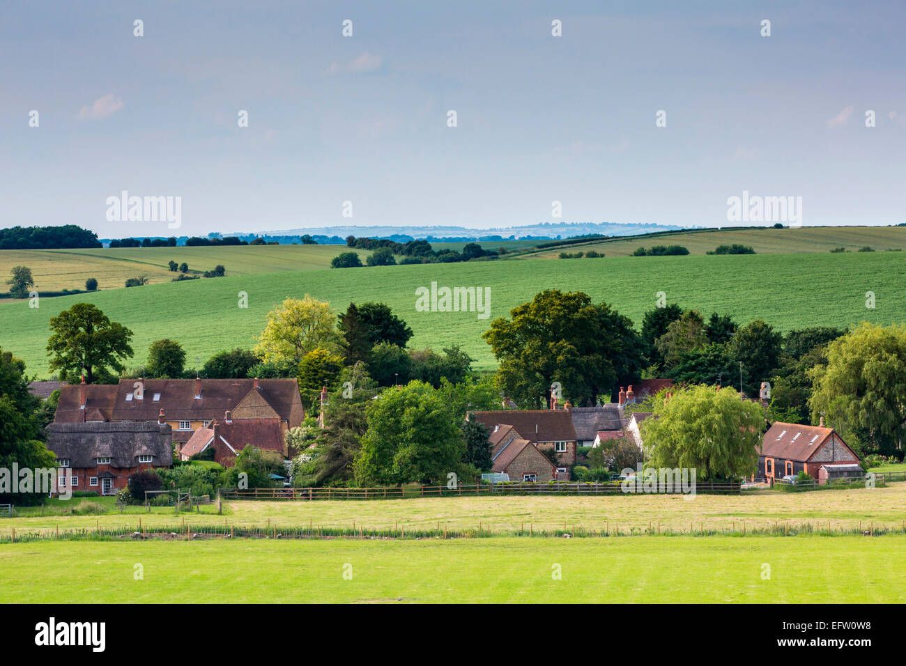 Distant view of traditional English village in rural landscape, Oxfordshire, UK Stock Photo