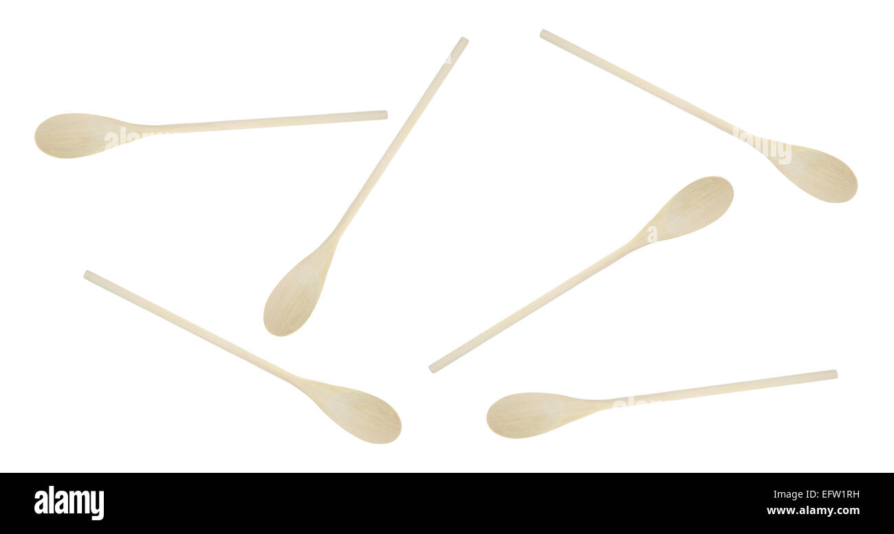 A group of new wood spoons scattered on a white background. Stock Photo