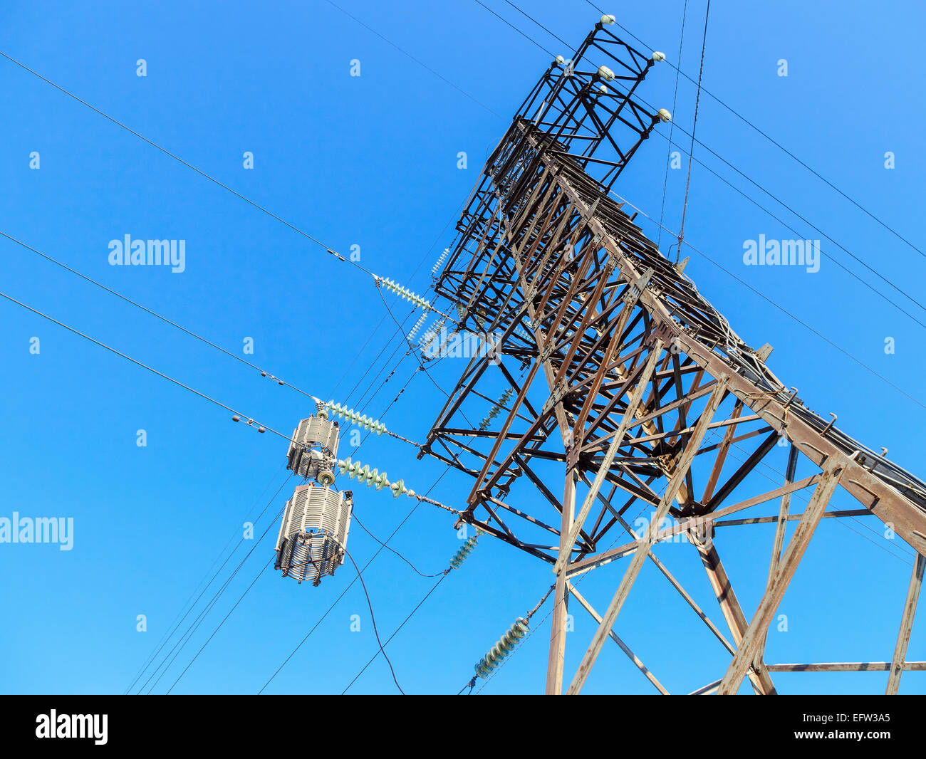 High voltage electric tower against the blue sky Stock Photo - Alamy