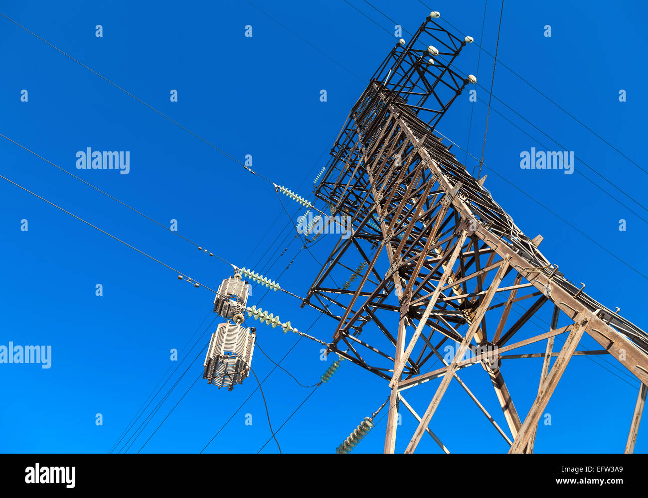 High voltage electric tower against the blue sky Stock Photo - Alamy