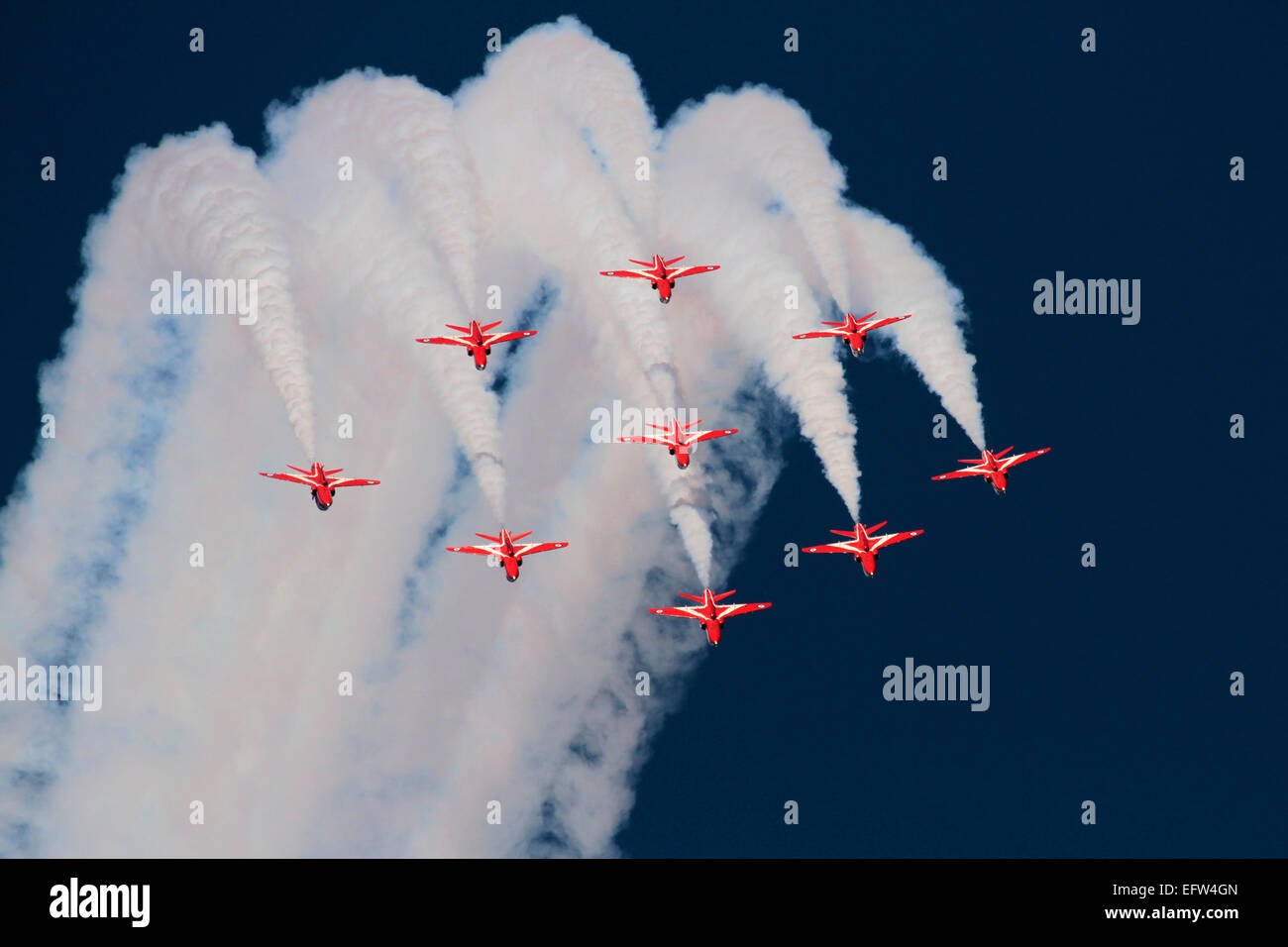 The Red Arrows aerobatic display team of Britain's Royal Air Force performing a formation loop during an airshow display Stock Photo
