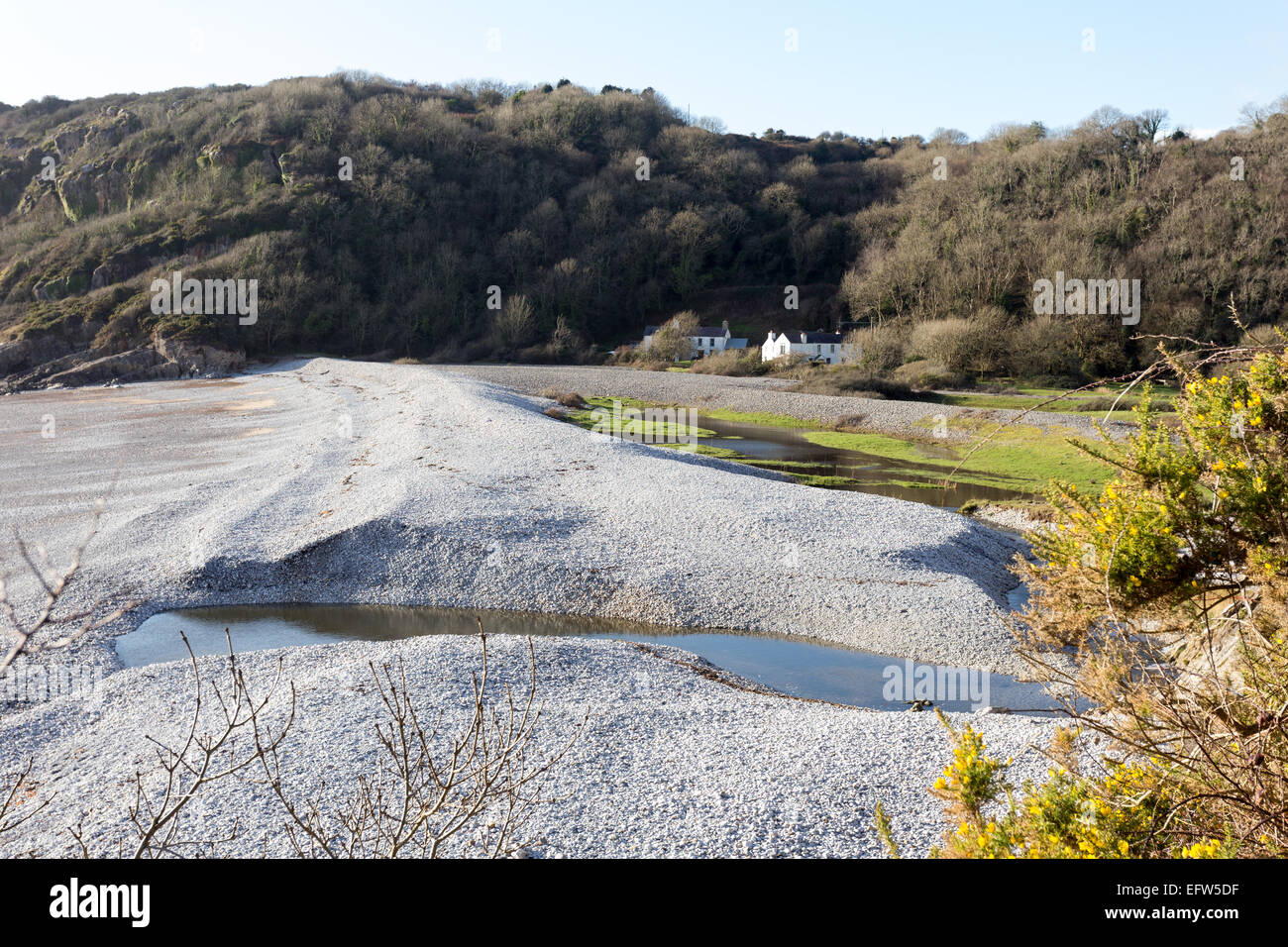 Pwlldu Site of Special Scientific Interest on the Wales Coast Path in the Gower. The unusual shingle beach damming a river is on Stock Photo