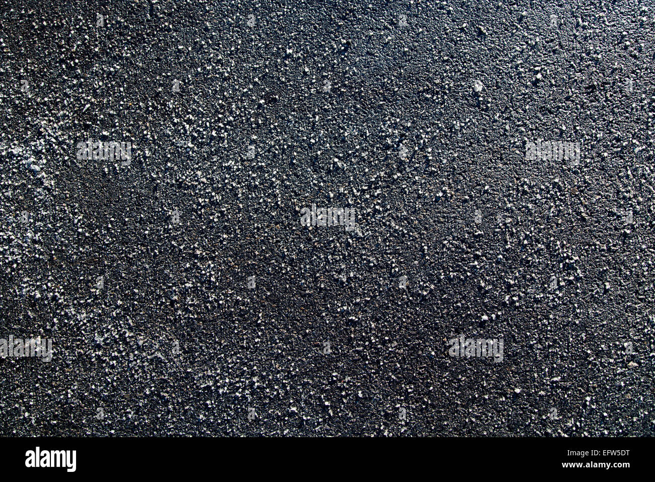 Picture of a piece of asphalt littered with salt Stock Photo