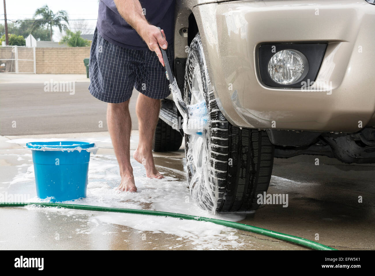 Bucket full of soap suds and hand washing Stock Photo - Alamy