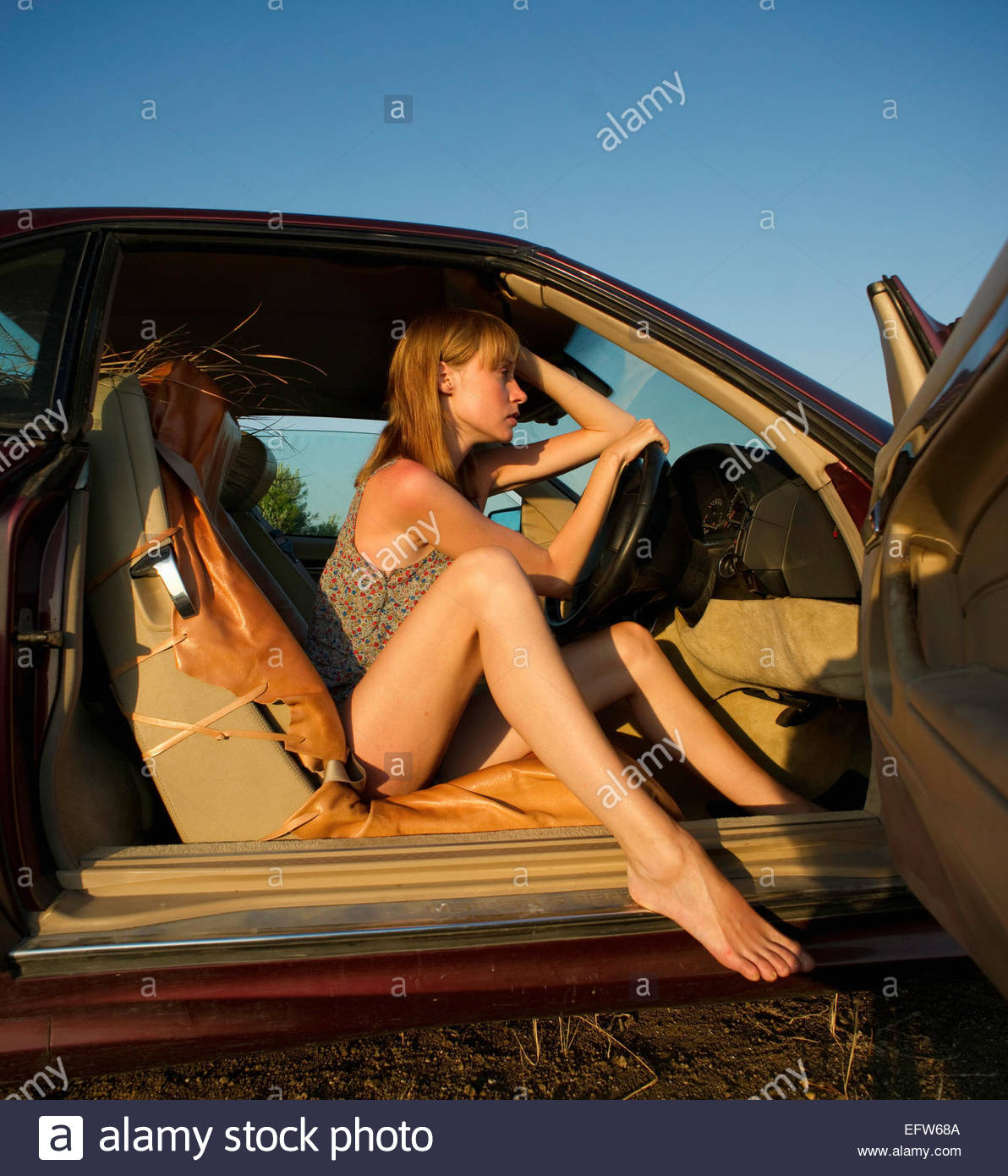 https://c8.alamy.com/comp/EFW68A/woman-driver-sitting-in-a-sports-car-at-the-beach-barefoot-EFW68A.jpg