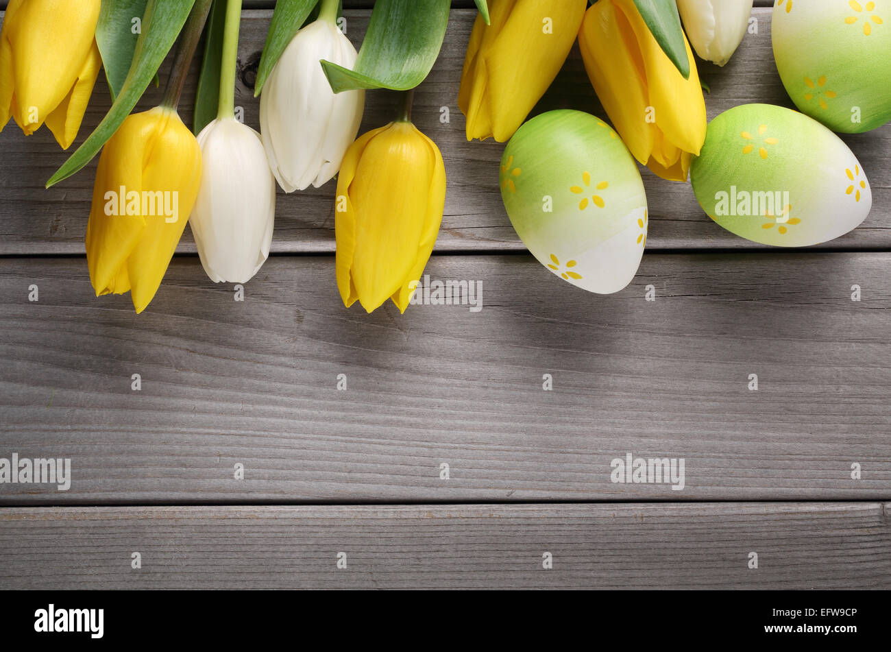 Tulips and easter eggs on wood background Stock Photo - Alamy