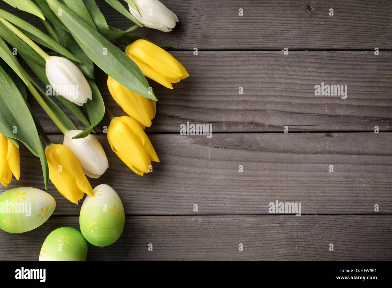 Tulips and easter eggs on wood background Stock Photo - Alamy