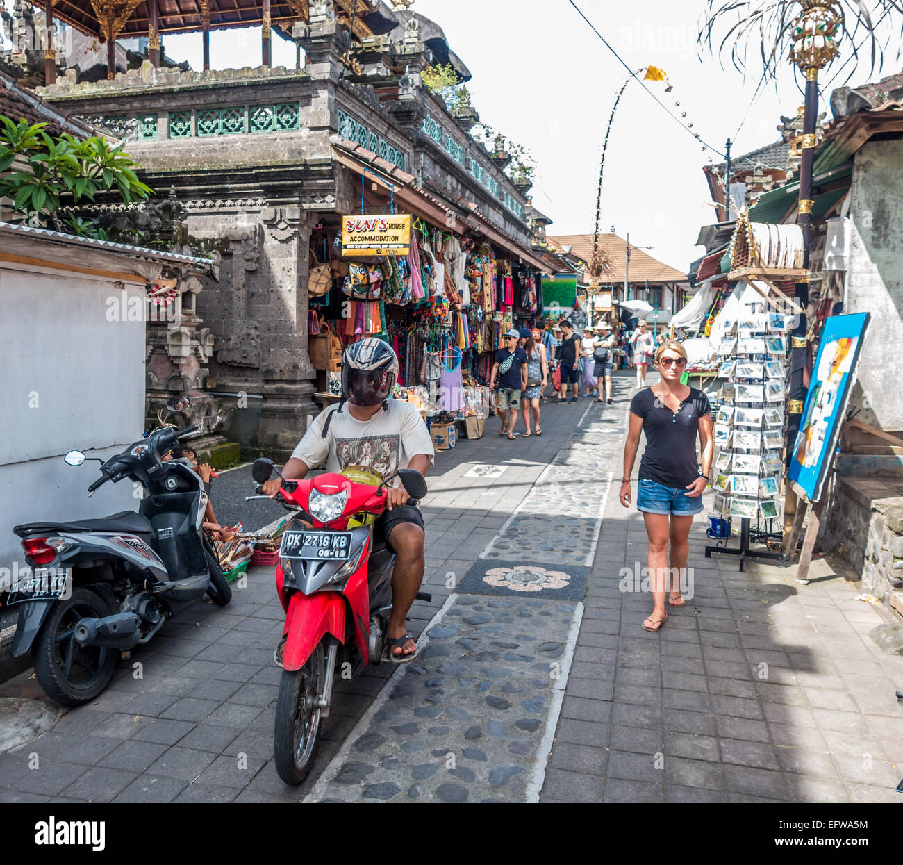 A motorbike traverses a market laneway in Ubud, Bali, Indonesia Stock Photo