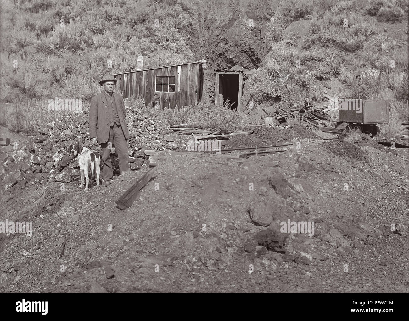Historic photo of a miner and his dog at a mine in Idaho, United States - The mine was possibly located in the Wood River Valley Stock Photo