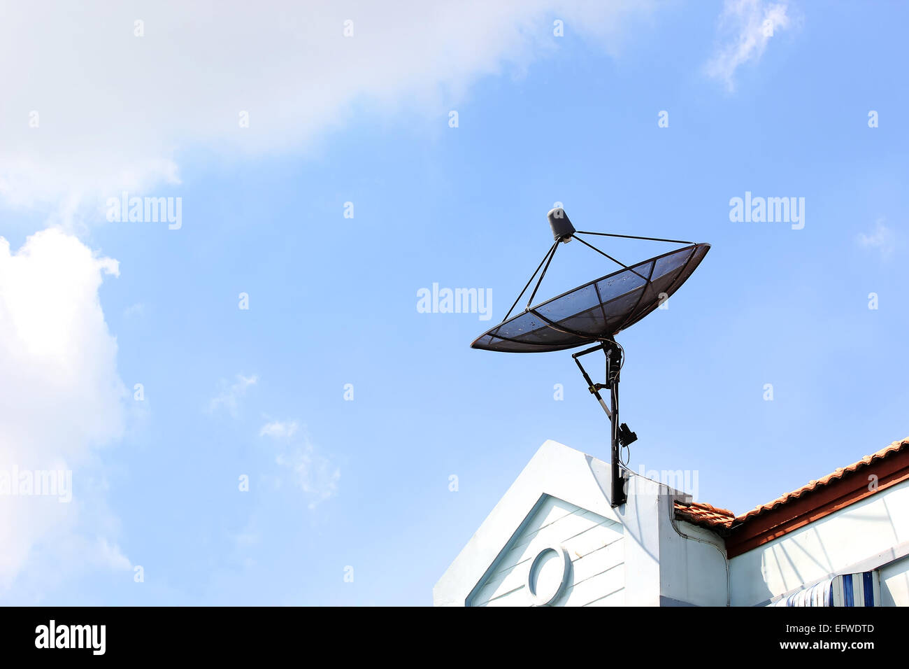 Satellite dish on roof with beautiful sky Stock Photo