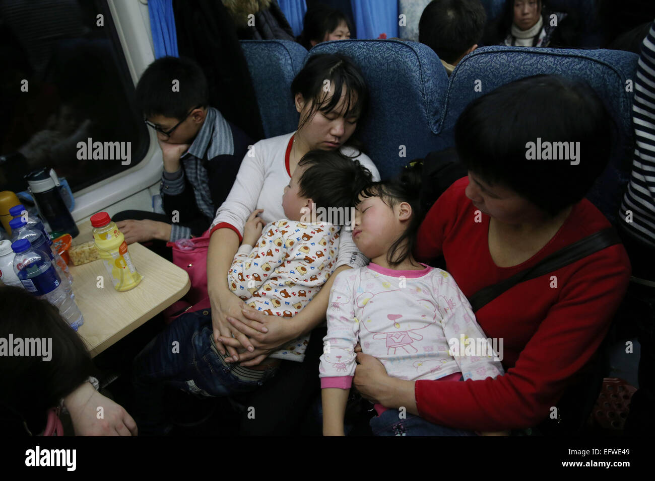 Shanghai, China's Sichuan Province. 9th Sep, 2015. Children have a sleep in parents' arms on train 3663, which runs from east China's Shanghai to Chengdu, capital of southwest China's Sichuan Province, on Sept. 9, 2015. The Spring Festival, or the Chinese lunar New Year which starts from Feb. 19 this year, is known as the world's biggest migration, with millions of people traveling vast distances for family reunions. © Ding Ting/Xinhua/Alamy Live News Stock Photo