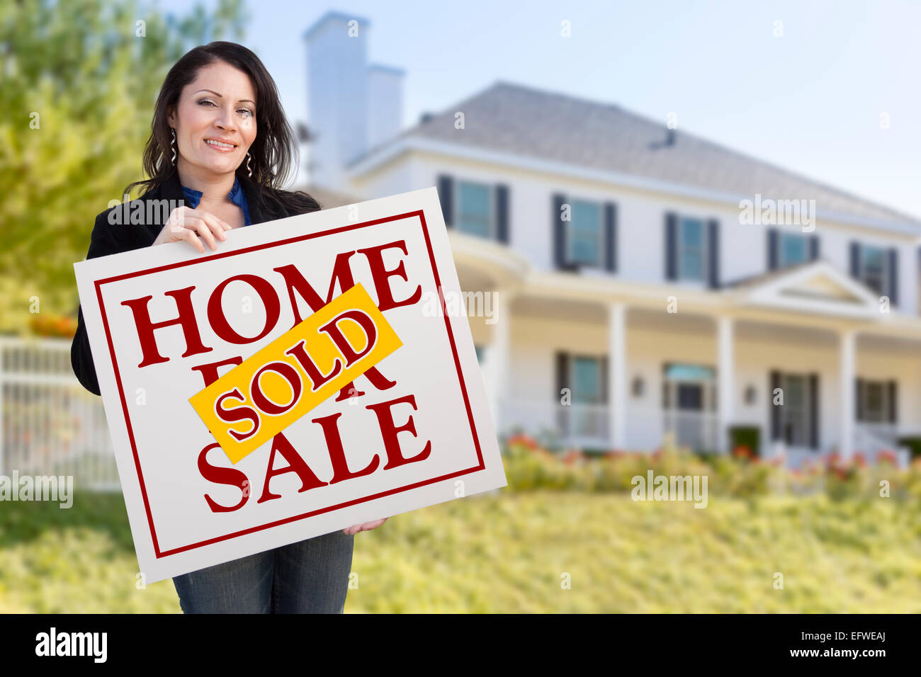 Female realtor holding sold sign hi-res stock photography and images ...