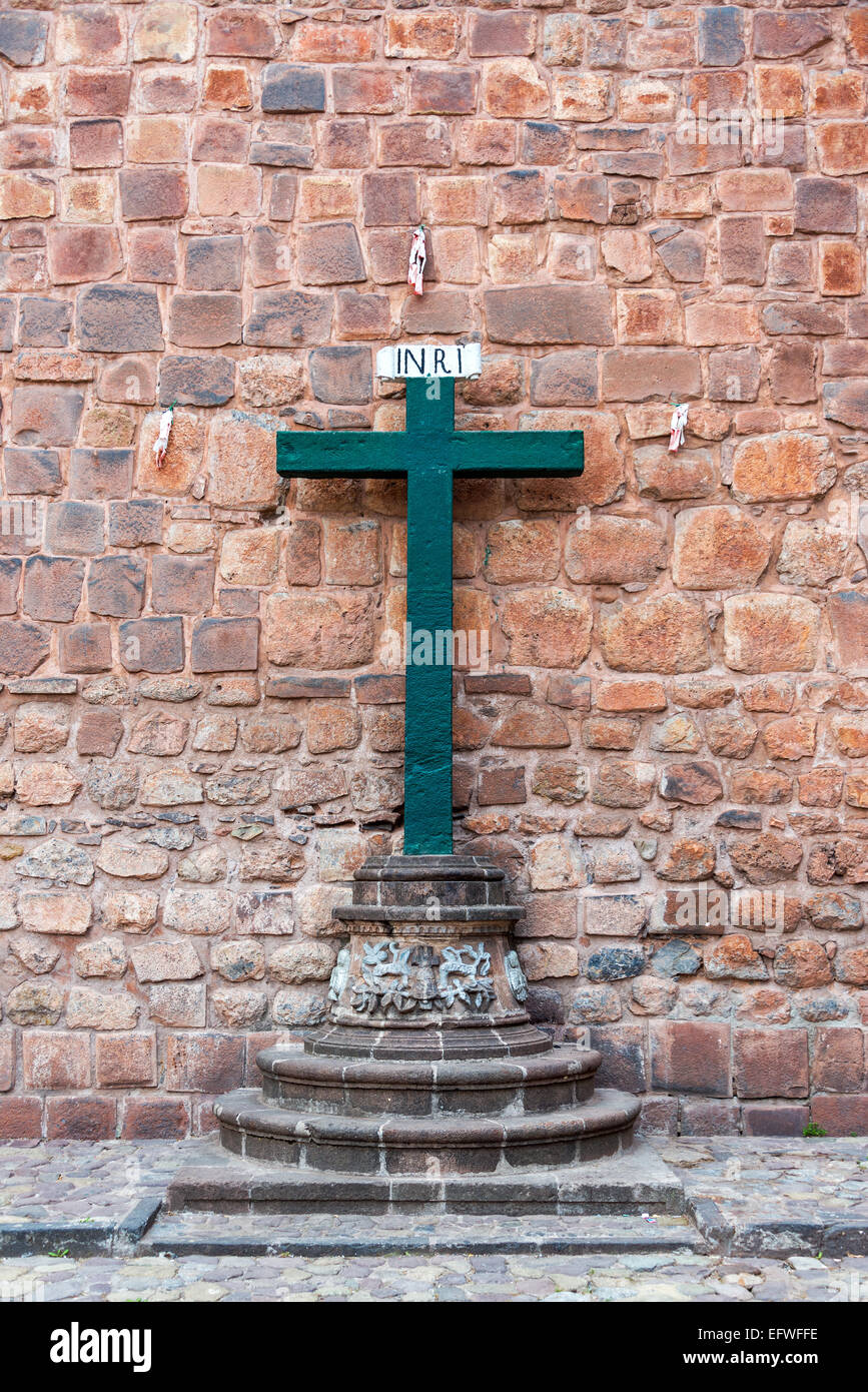 Green cross in front of the cathedral in Cusco, Peru Stock Photo