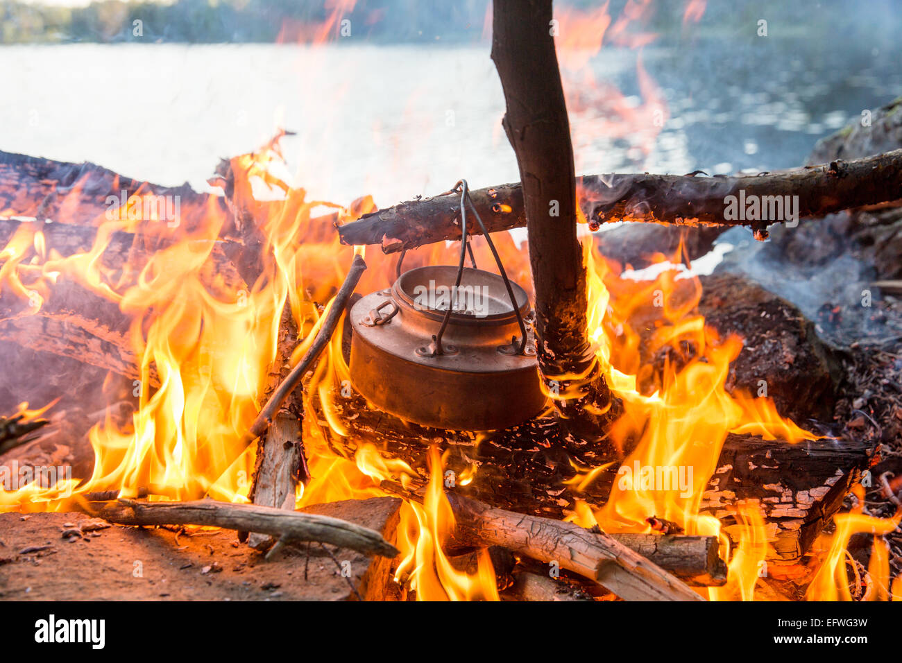 Campfire, old coffee pot on the fire hires stock photography and