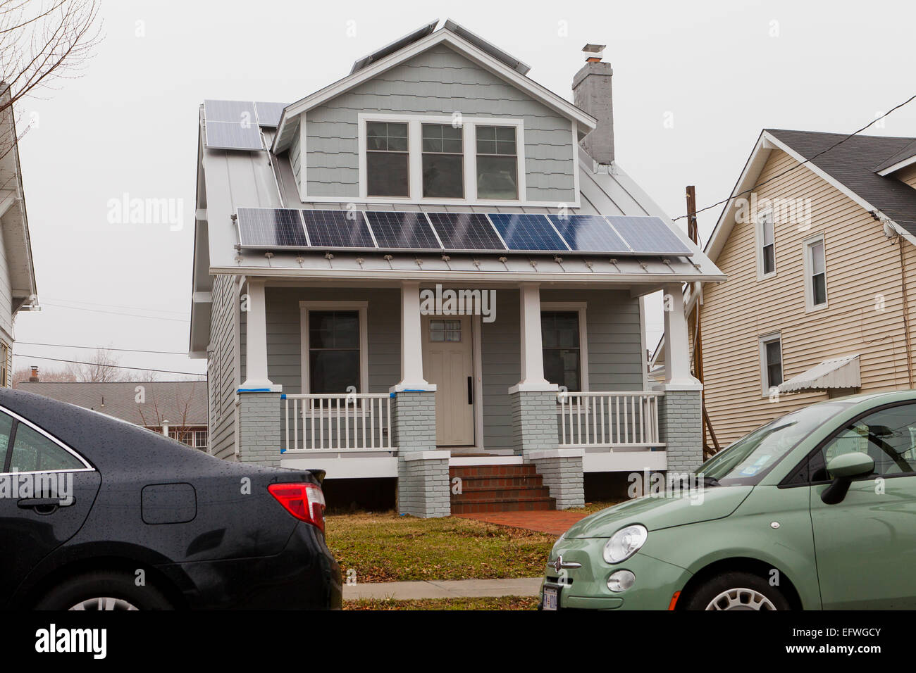 Solar panels on roof of small house - USA Stock Photo