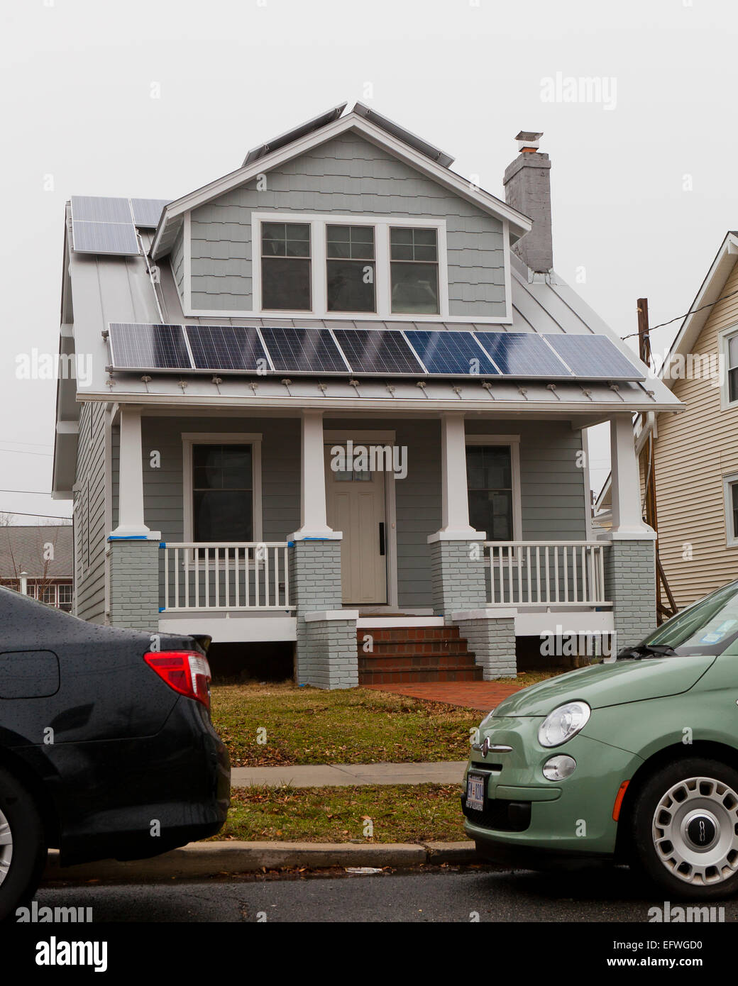 Solar panels on roof of small house - USA Stock Photo