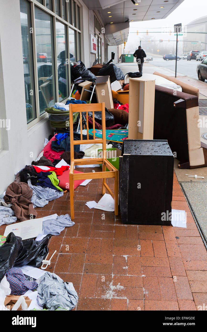 Furniture of evicted tenant on sidewalk of apartment building - USA Stock Photo