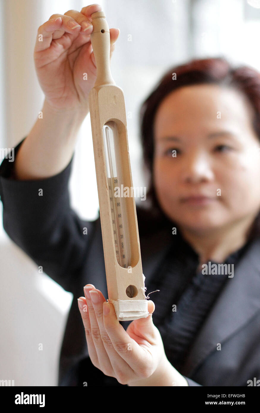 (150211) -- VANCOUVER, Feb. 11, 2015 (Xinhua) -- A nursing school alumni displays a thermometer used in early 19th century during the nursing school celebration event at University of British Columbia in Richmond, Canada, Feb. 10, 2015. In honour of the Canadian nursing pioneer Ethel Johns (1879-1968) named as National Historic Person of Canada, the School of Nursing in University of British Columbia held an event displaying the former nursing uniforms and historic nursing tools during the World War I to commemorate her contribution. Ethel Johns established the first university degree nursing Stock Photo