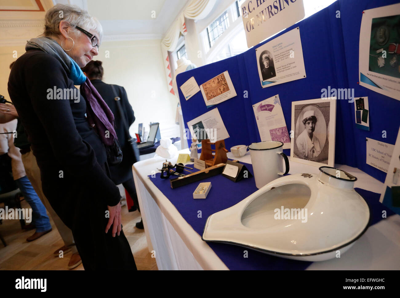 (150211) -- VANCOUVER, Feb. 11, 2015 (Xinhua) -- A visitor looks at some historic nursing tools during the nursing school celebration event at University of British Columbia in Richmond, Canada, Feb. 10, 2015. In honour of the Canadian nursing pioneer Ethel Johns (1879-1968) named as National Historic Person of Canada, the School of Nursing in University of British Columbia held an event displaying the former nursing uniforms and historic nursing tools during the World War I to commemorate her contribution. Ethel Johns established the first university degree nursing program in Canada at the Un Stock Photo