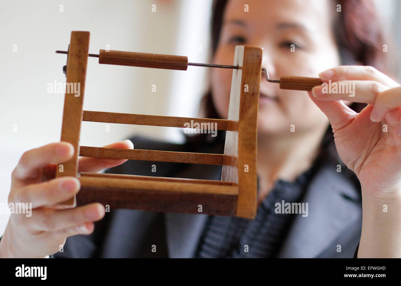 (150211) -- VANCOUVER, Feb. 11, 2015 (Xinhua) -- A nursing school alumni displays a wooden bandage roller during the nursing school celebration event at University of British Columbia in Richmond, Canada, Feb. 10, 2015. In honour of the Canadian nursing pioneer Ethel Johns (1879-1968) named as National Historic Person of Canada, the School of Nursing in University of British Columbia held an event displaying the former nursing uniforms and historic nursing tools during the World War I to commemorate her contribution. Ethel Johns established the first university degree nursing program in Canada Stock Photo