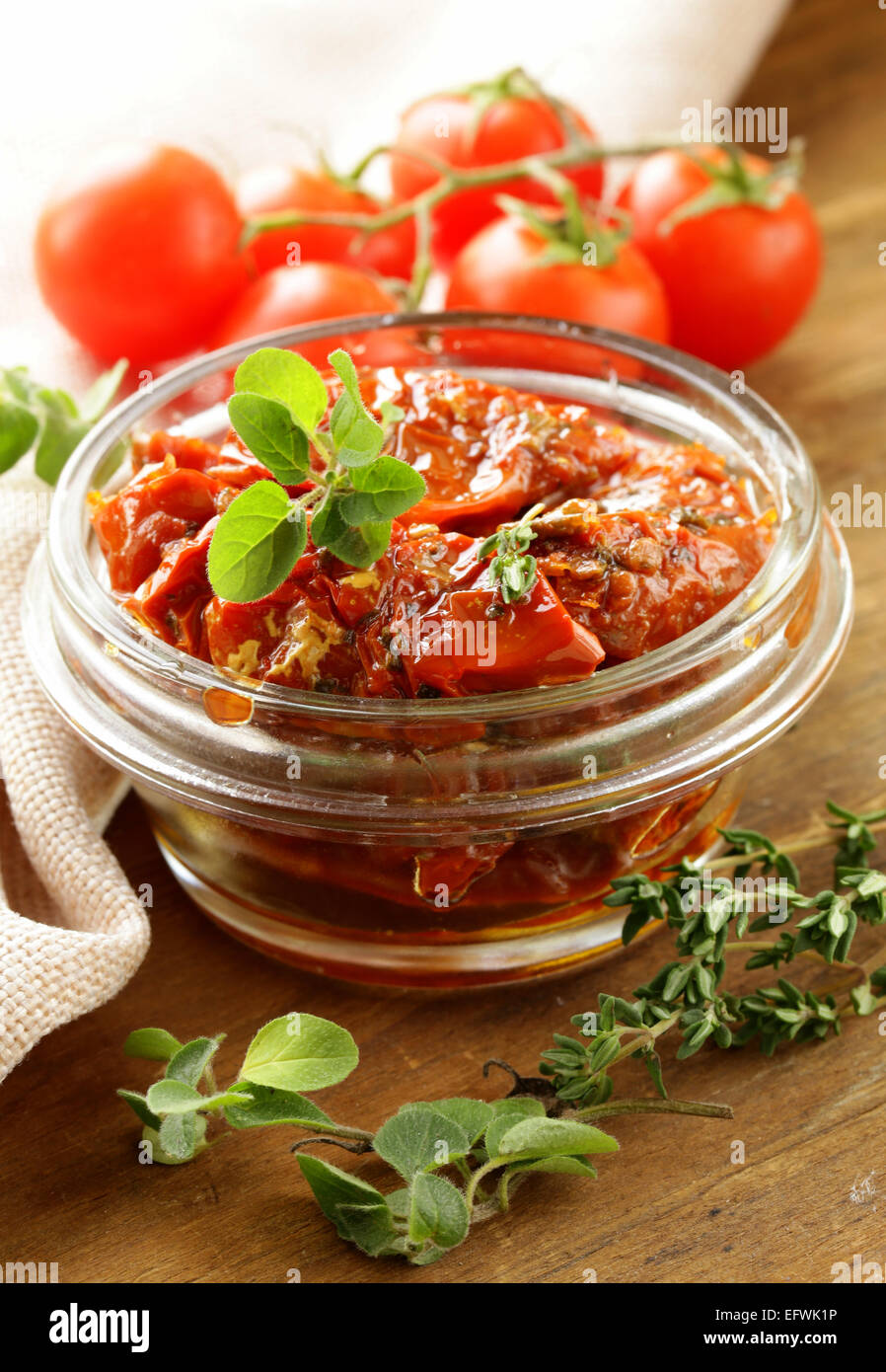 sundried tomatoes with herbs in a glass jar Stock Photo Alamy
