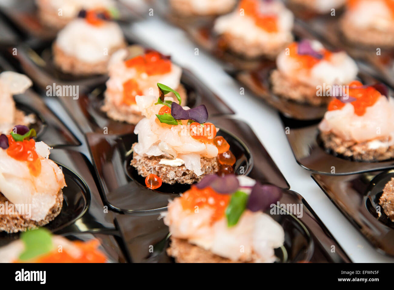 Appetizer of Salmon eggs, fish, and green herbs canapés Stock Photo Alamy