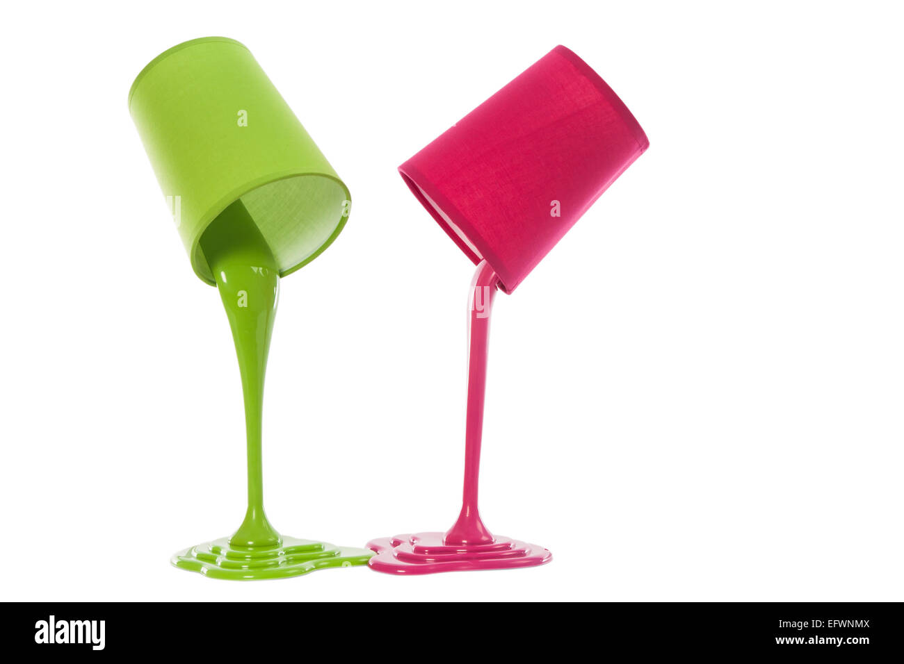 pouring paint from colored container on white background Stock Photo