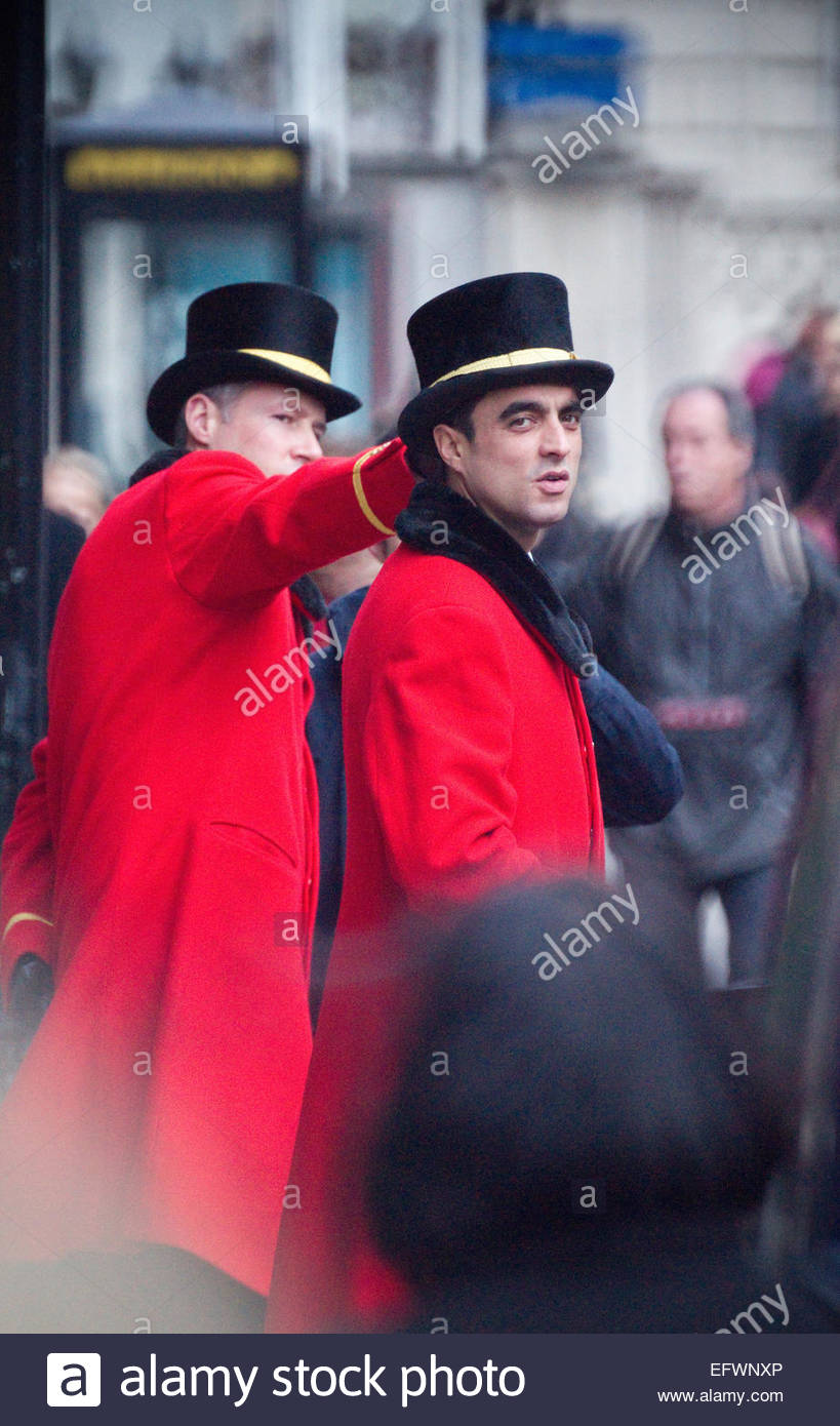Two Hotel Doorman Or Greeters Wearing Traditional Red Uniforms