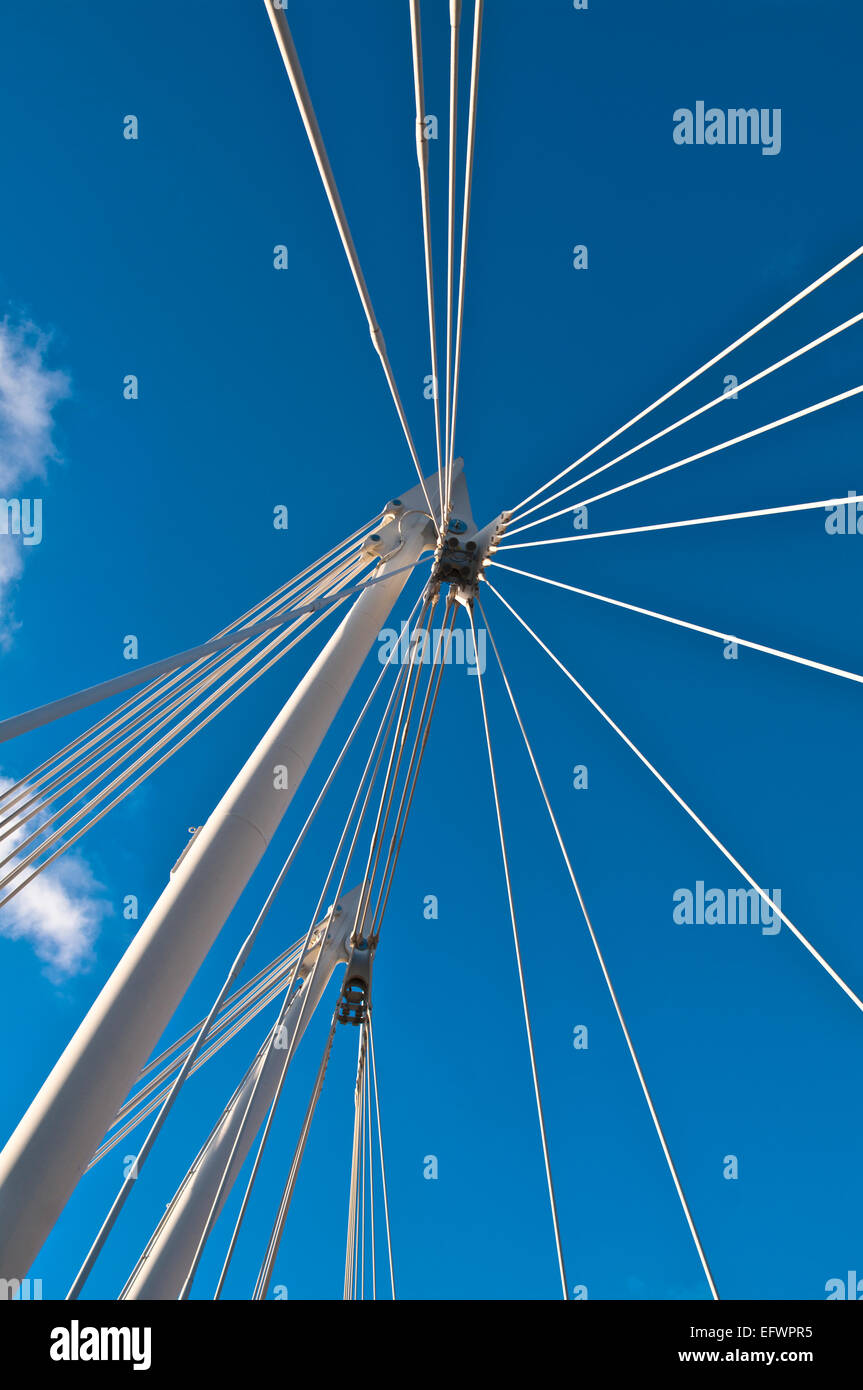 Structural detail of white metal pylons and cable stays of the Hungerford Bridge, London, seen against a deep blue sky, England Stock Photo